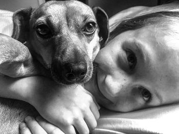 Portrait of woman with dog at home