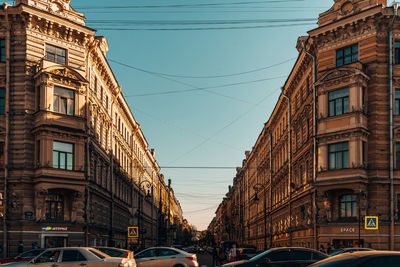 Cars on street amidst buildings in city