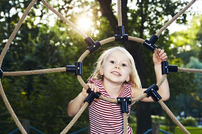 Girl climbing on ropes at playground, sweden