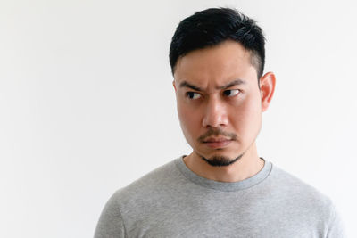 Portrait of young man against white background