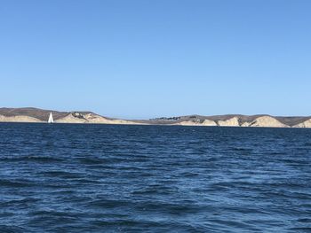 Scenic view of sea against clear blue sky
