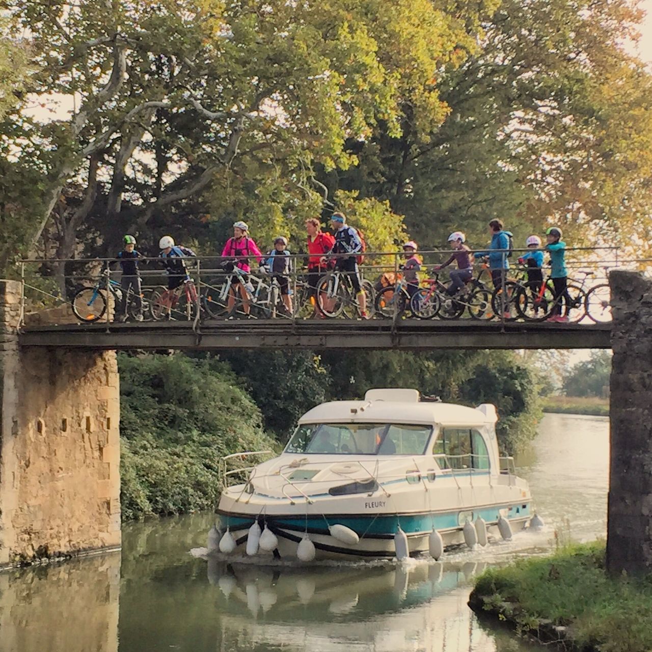 large group of people, tree, transportation, real people, water, leisure activity, mode of transport, day, outdoors, men, nature, river, nautical vessel, sport, lifestyles, helmet, competition, sports race, people