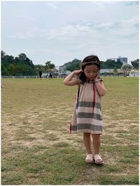 Portrait of girl standing on field