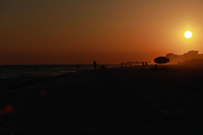 Scenic view of beach against sky during sunset