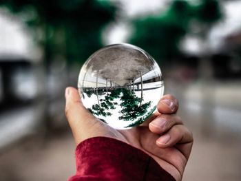 Close-up of hand holding ball glass