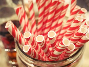 Close-up of drinking straws in container at cafe