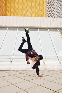 Full length of man skateboarding on floor