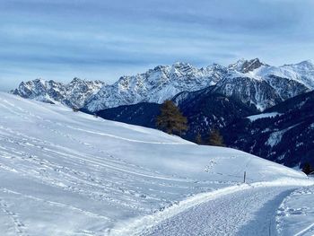 Scenic view of snow covered mountains against sky