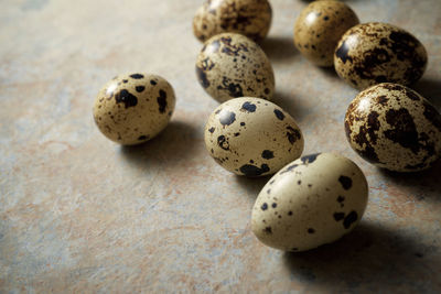 Quail eggs on a stone table.