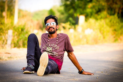 Portrait of young man sitting outdoors