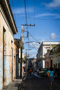 People walking on street amidst buildings in city