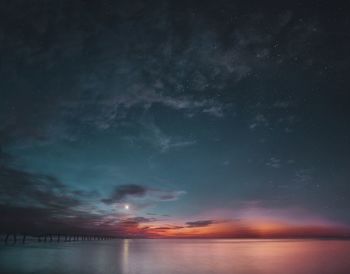 Scenic view of sea against sky at night