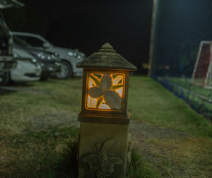 Close-up of illuminated sign on field