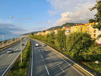 Road by city against sky