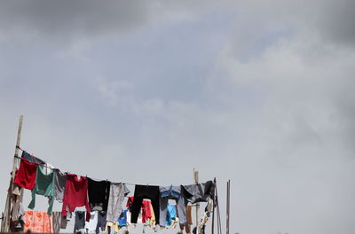 Low angle view of clothes drying against sky