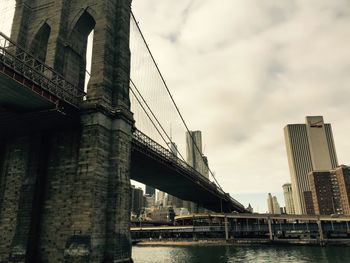 Low angle view of suspension bridge against sky