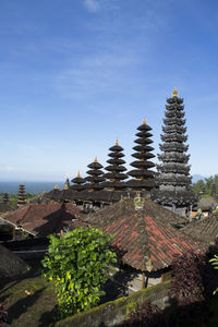 Plants growing outside building against blue sky. besakih temple, bali, indonesia