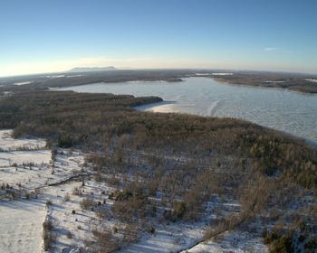 Scenic view of landscape against clear sky during winter
