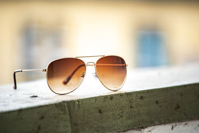Close-up of sunglasses on retaining wall