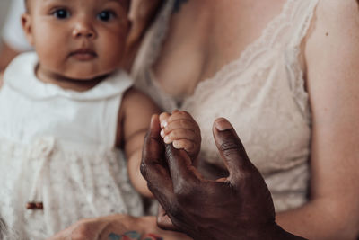 Close-up of baby hand on bed