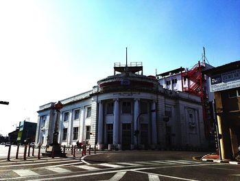 View of buildings against clear blue sky