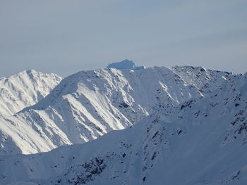 Scenic view of snowcapped mountains against clear sky