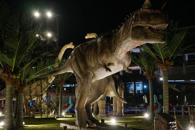 Statue of illuminated city at night