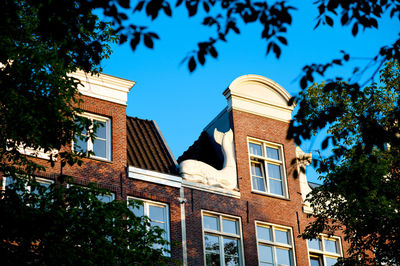 Low angle view of buildings against blue sky