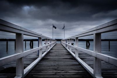 Footbridge over pier against sky