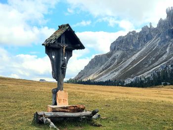 Traditional windmill on field against sky