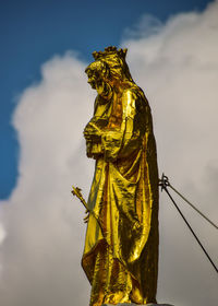 Low angle view of statue against cloudy sky