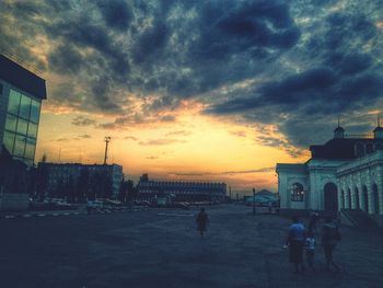 Buildings against cloudy sky at sunset