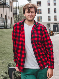 Portrait of young man standing on field