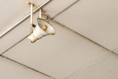 Low angle view of light bulbs hanging from ceiling