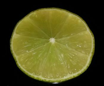 Close-up of lime against black background
