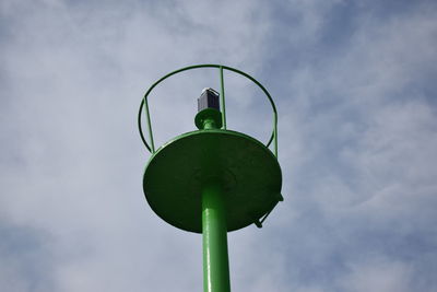 Low angle view of green lighthouse against sky