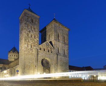 Low angle view of illuminated building against blue sky