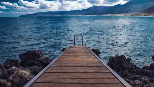 Pier over sea against sky