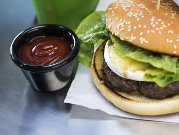 High angle view hamburger with sauce on table