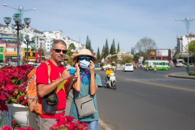 Portrait of friends on street in city