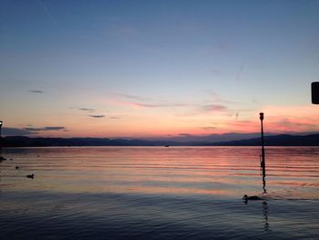 Scenic view of lake at sunset