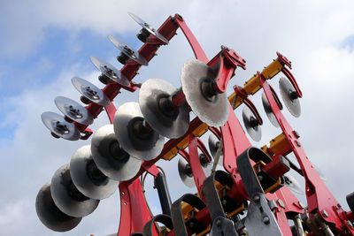 Low angle view of machine part against sky