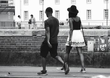 People walking on zebra crossing in city