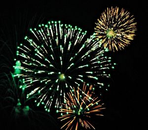 Low angle view of firework display at night