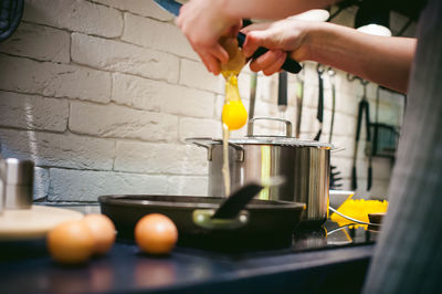 Cropped hands of woman preparing food in kitchen at home