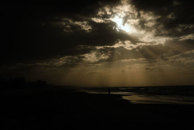 Scenic view of sea against storm clouds