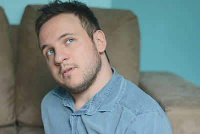 Portrait of young man sitting at home