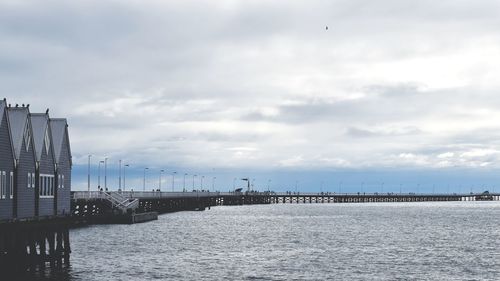 Scenic view of sea by buildings against sky