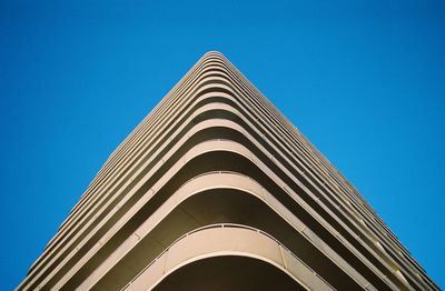 Low angle view of building against clear blue sky