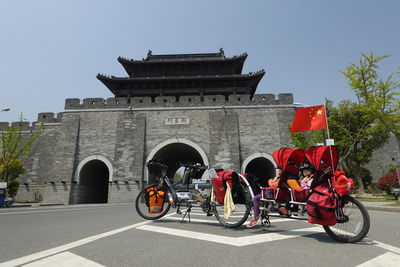 Siblings sitting in baby stroller against temple